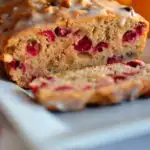 Cranberry bread with a piece sliced off to show the cross section