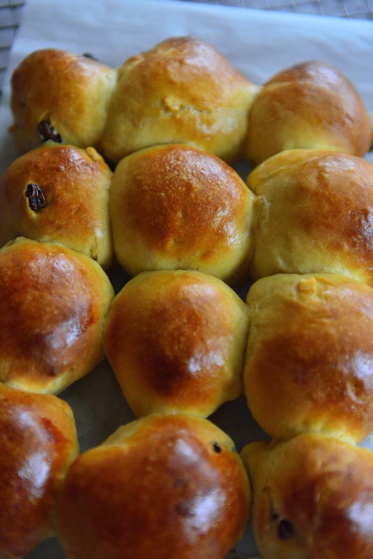 Hot cross buns out of the oven before the crosses are added on top.