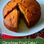 Christmas fruit cake on a white platter with caption - image for pinning