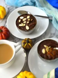 Two bowls of Pumpkin halva in small bowls and a cup of tea
