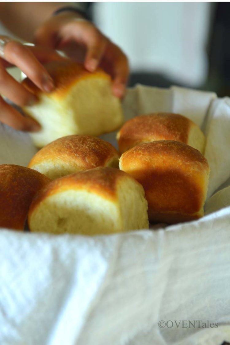 Placing pav buns in a bread basket.