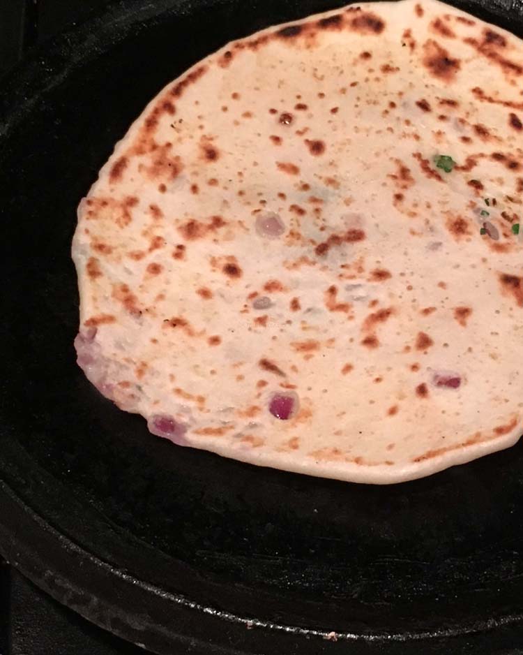 Cooking Kulcha topped with onions