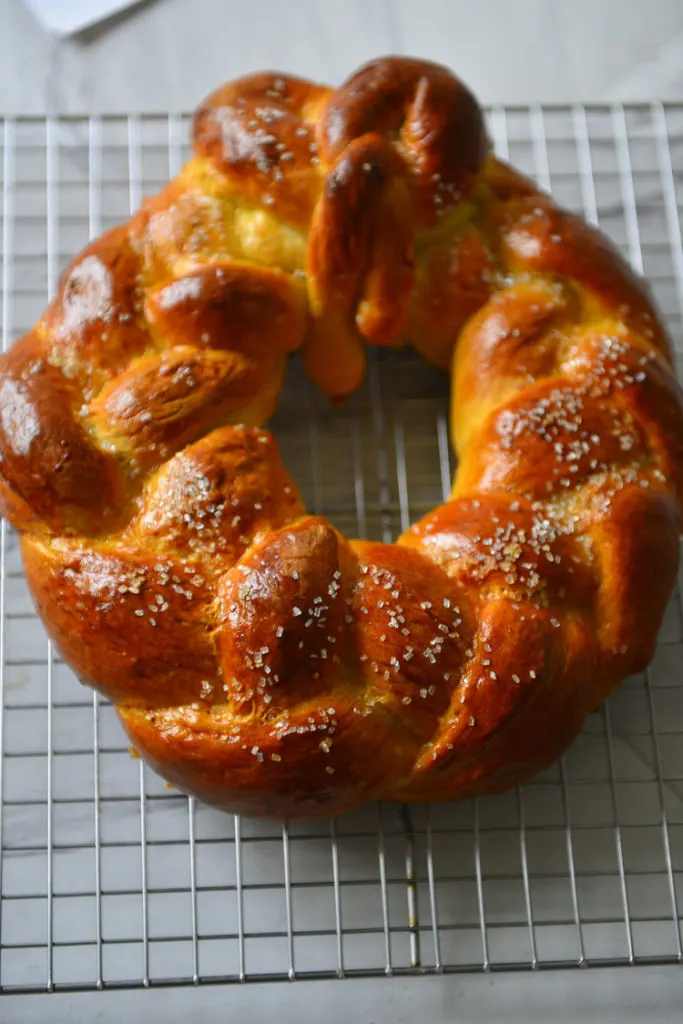 A cardamom bread wreath resting on the cooling rack