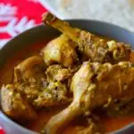 Duck curry in a serving bowl with caption. Image for Pinning
