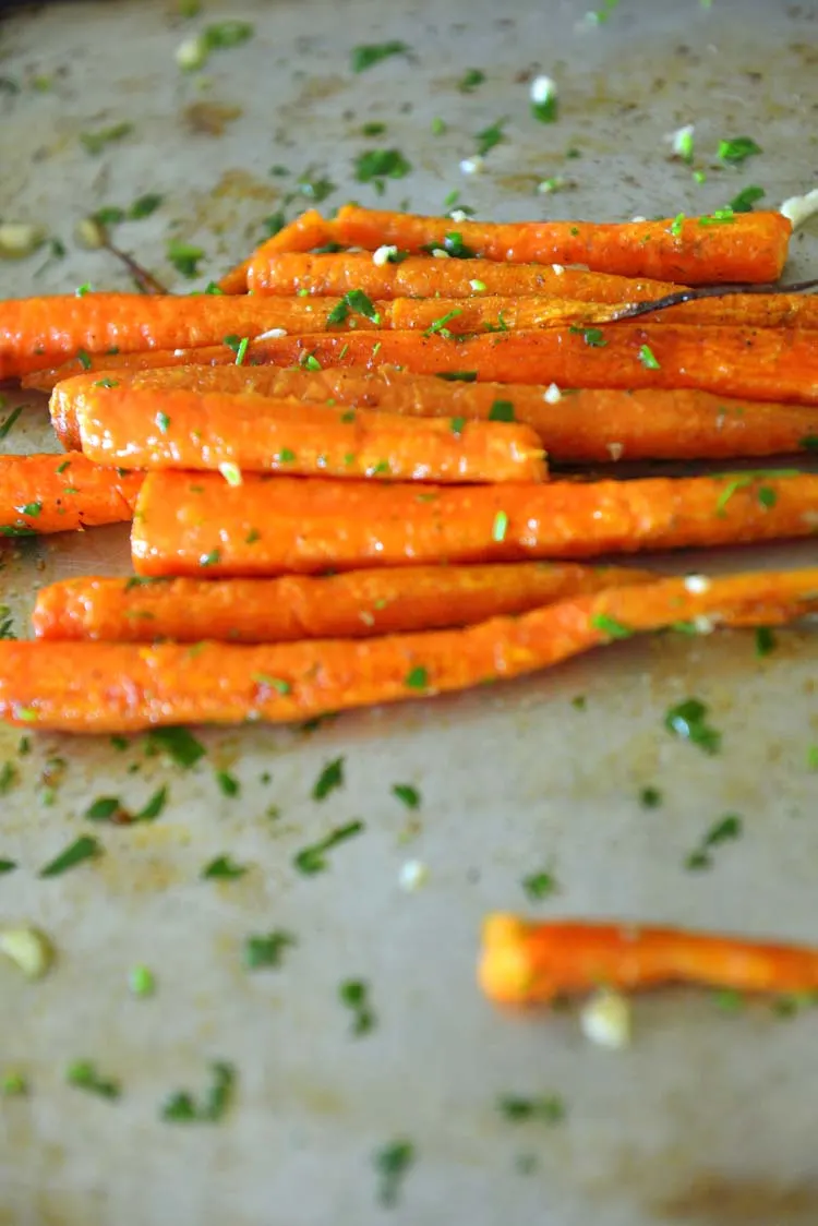 Partially roast carrots on a sheet pan
