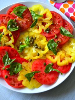Garden Tomato Salad made with sliced colorful heirloom tomatoes on a plate