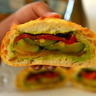 Cross section of a picnic loaf sandwich showing the layers of vegetables.