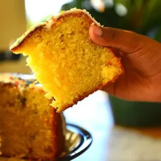 Hand holding a slice of Kulich showing its cake like crumb.