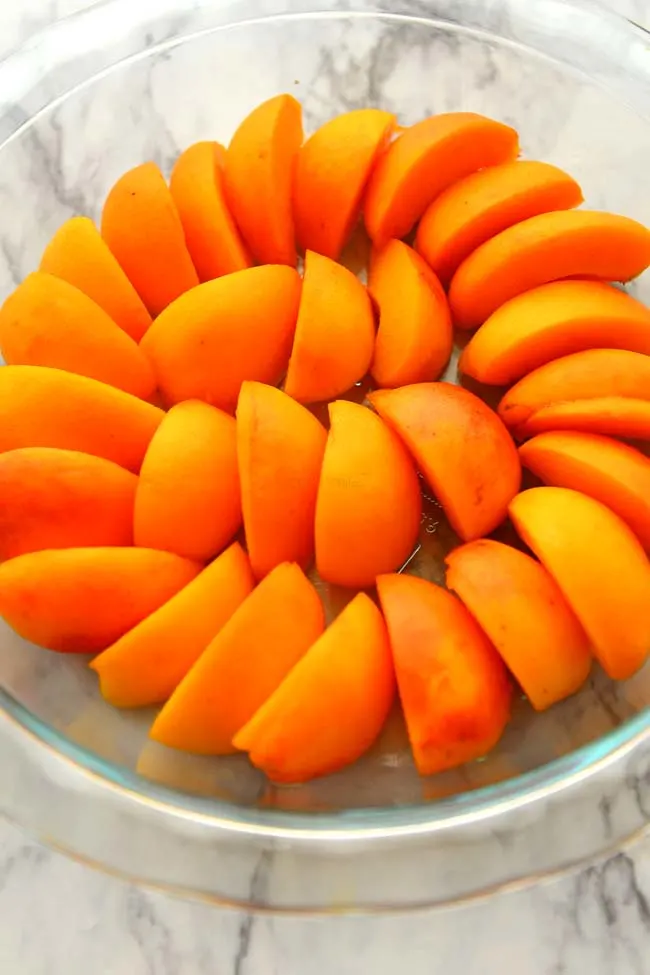 Sliced Apricots arranged in the pie dish for making Apricot Clafoutis