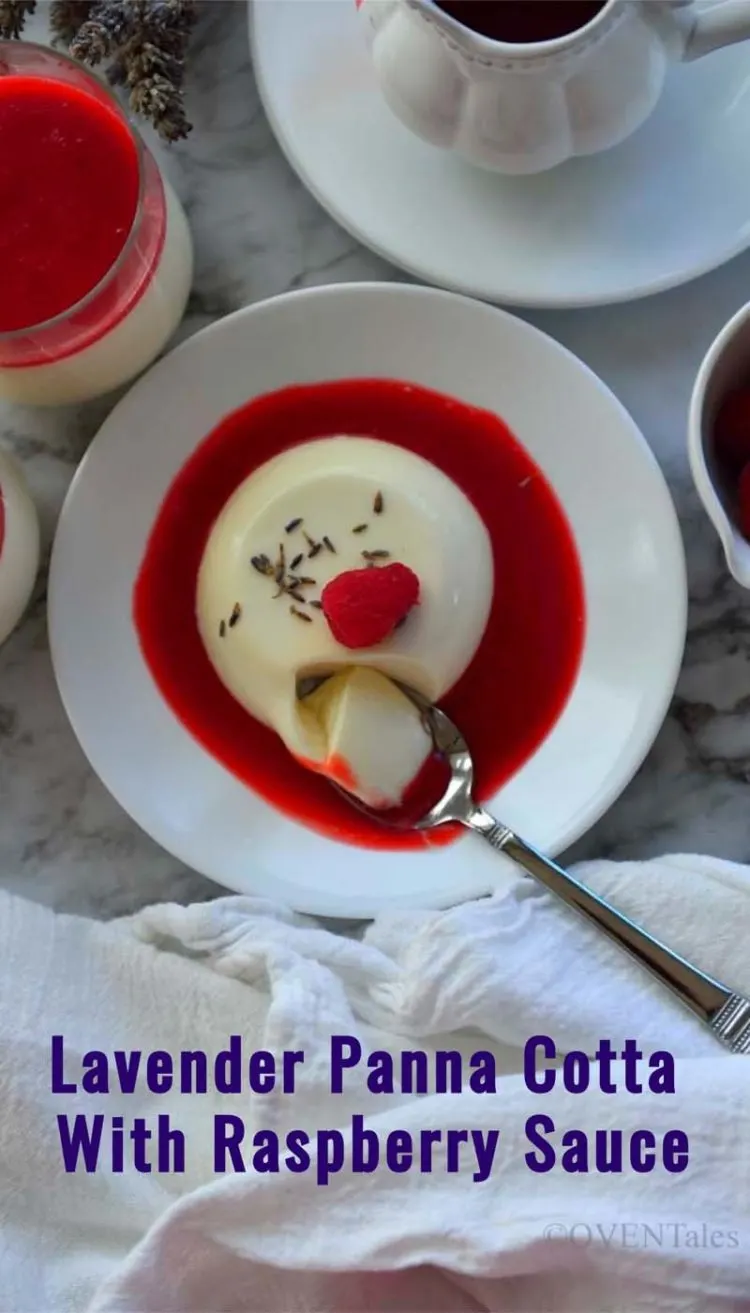 Pinnable image of lavender panna cotta on a white plate with red sauce around it . A spoon dipping into it and captioned - Lavender Panna Cotta With Raspberry Sauce