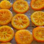 Candied orange slices on a cooling rack with caption 'Candied Orange Slices'.
