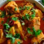 Image for pinning - chicken curry in a bowl with bread flat breads on the side and caption "Chicken Madras - Easy Instant Pot Verion".