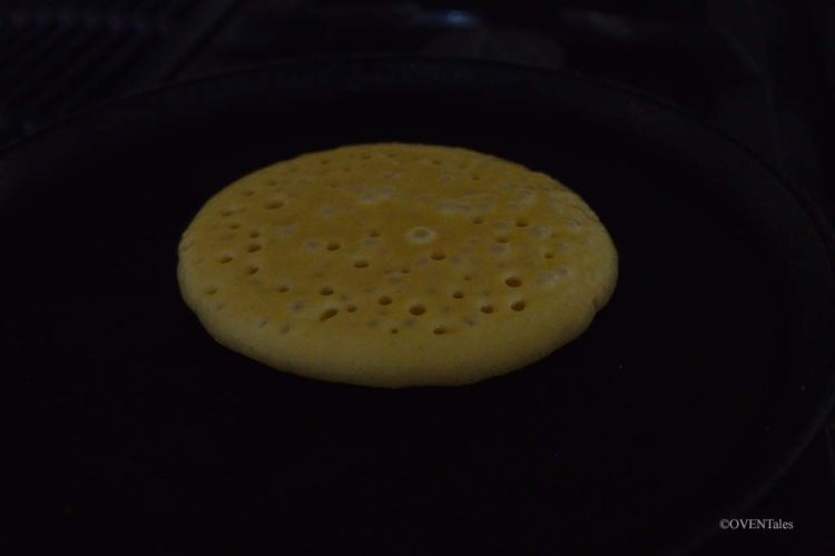 Pancake cooking on a griddle.